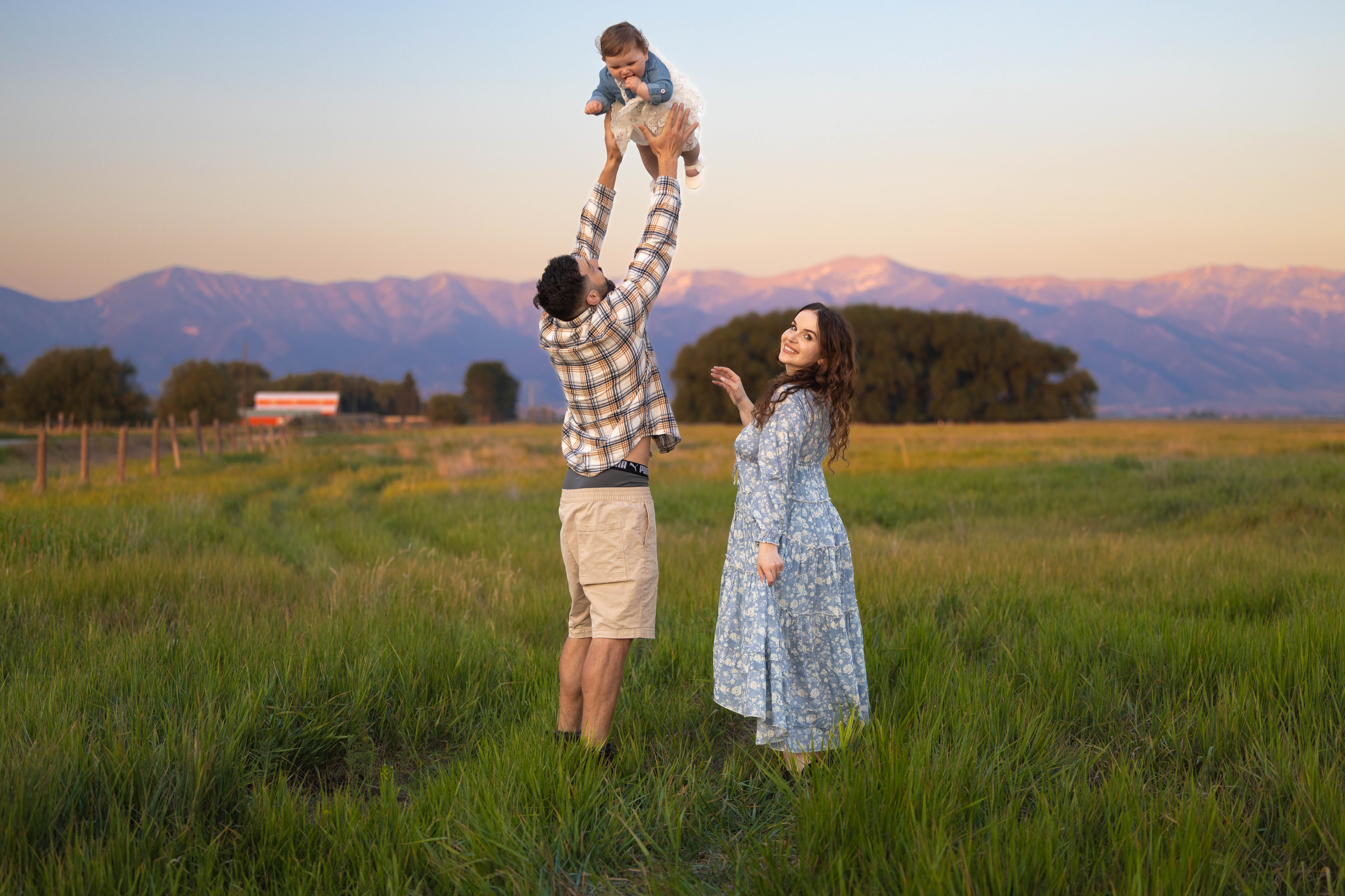 Parents walking hand-in-hand with children